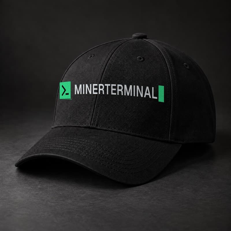 Mockup of a black baseball cap with the full MinerTerminal logo, the green terminal prompt mark and the wordmark